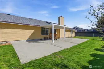 Another view of the fully fenced backyard, large patio and beautiful lawn--just in time for warm weather entertaining!