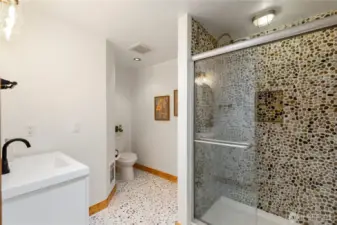 Refreshed primary bathroom...yes those are smooth stones...it's BEAUTIFUL!