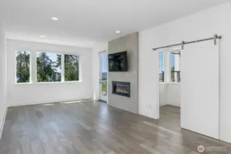 The barn door is to the office. Note the cozy gas fireplace. The glass door is to the view deck.