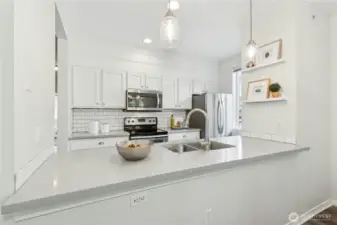 Redone kitchen with quartz counters, and subway tile.