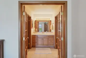 French doors in primary leads to bathroom and wardrobe closet