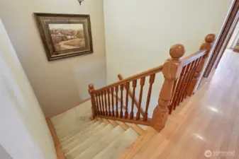 staircase from upper level to lower level- original hardwood floors on upper level