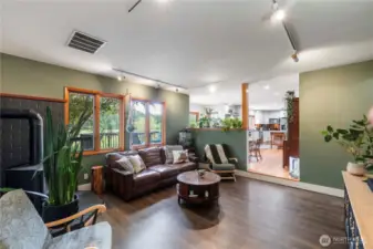 Step down into the formal living room and soak up the views through multiple windows overlooking the property.