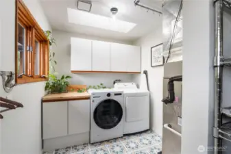 Spacious laundry room with new washer and dryer conveniently located through the walk-in pantry off the kitchen. All appliances are included.