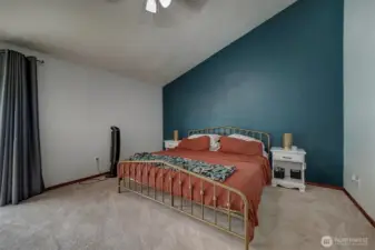Primary bedroom with vaulted ceilings.