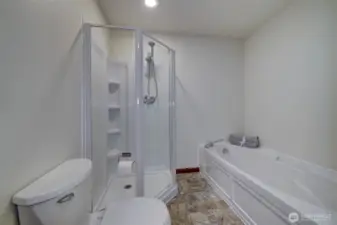 Primary attached full bath with soaking tub.