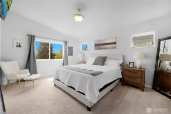 Primary bedroom with vaulted ceilings, tons of light and backs to orchard greenery