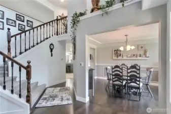 Grand Staircase leading you to the upstairs level - Wide doorway to the Dining Room enhances the open concept