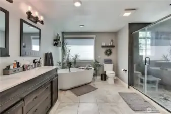 Spacious and luxurious Master Bathroom featuring a freestanding soaker tub, a refreshing walk-in shower, and a custom-designed vanity area, providing both comfort and elegance.