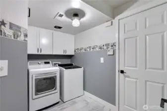 This property boasts a generously sized laundry room, complete with built-in storage cabinets, providing excellent organization and functionality for all your household needs.