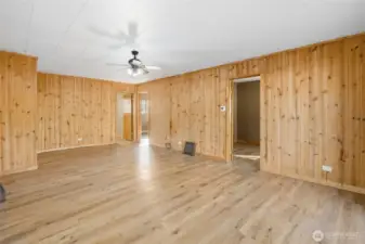 Living space with access into two bedrooms and office.