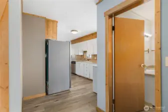View from back entry into kitchen and bathroom.