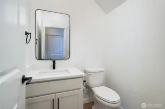 Main level half bath - Features and colors may differ.
