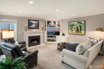 Family room with custom built-in cabinet and gas buring fireplace insert with remote.