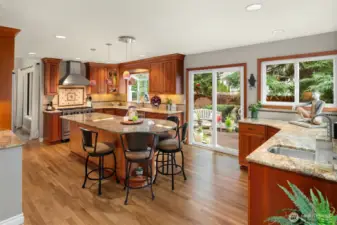 Chef's kitchen with cherry cabinetry, Viking 6 burner gas freestanding stove and hood.
