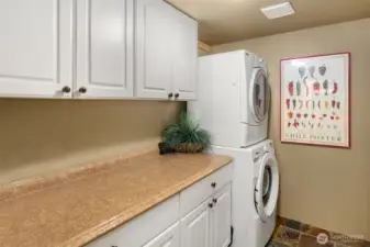 Laundry room with lots of storage and stacking W/D. It is plumbed for a sink that could easily be added.