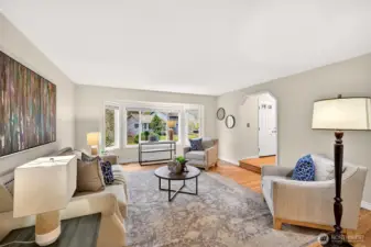 From this angle, the living room shows its spacious proportions and easy connection to the rest of the main level. The bay window expands the room visually and brings in a soft, natural brightness buyers are always looking for.
