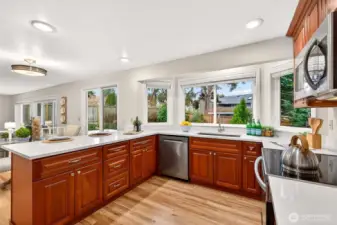 The kitchen has been thoughtfully improved with new quartz countertops and sink, abundant cherry cabinetry, and generous prep space that supports both daily routines and entertaining. New LG stainless range and dishwasher add everyday convenience while large windows bring in natural light
