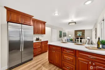This view emphasizes the kitchen’s practical layout and strong connection to the adjacent living areas, something buyers consistently value. Extensive cabinetry, durable surfaces, and a bright workspace make this kitchen both attractive and highly functional.