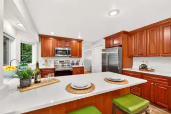 A wide peninsula offers flexibility for serving, casual dining, and conversation while keeping the kitchen open to the surrounding spaces. Buyers will appreciate the balance of storage, prep area, and connectivity that makes this room the heart of the home.