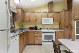 Newer Corian countertops and gorgeous newer cabinetry make this a fabulous kitchen you'll love. It has a seating area and there is also a formal dining room area nearby.