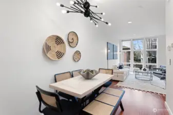 Dining room features a modern light fixture with horizontal lines complimenting the architecture of this 2009 built townhome.