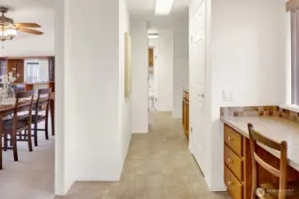 View from kitchen; built-in desk and closet/pantry near kitchen, off entry of garage area.