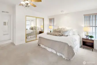 Large primary bedroom with ceiling fan.