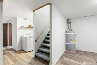 Stairs that lead up to the mud room with exterior access