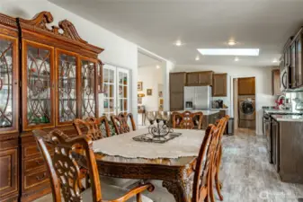 Dining area open to the kitchen and living room. To the right is a slider out to the backyard and covered deck.