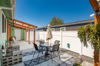 Low maintenance back yard with covered patio and covered deck. Fully fenced! Door in background is the garage.