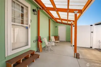 Low maintenance back yard with covered patio and covered deck. Fully fenced! Door in background is the garage.