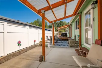 Low maintenance back yard with covered patio and covered deck. Fully fenced all the way around the other side of the home.