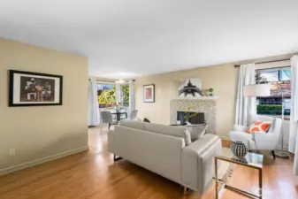 Hardwood floors, vintage lighting, and big corner windows are welcoming details.