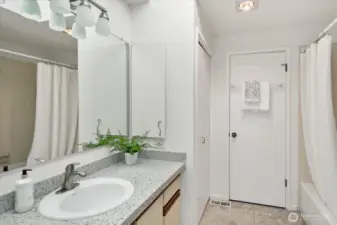 Full bath is light and bright and shared between the two bedrooms