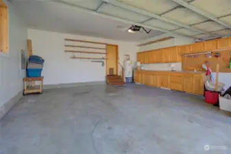 Large, two car garage also has storage and a nice work bench.