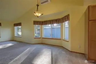 Dining area has plenty of room for seating and entertaining, as well as more big windows to enjoy the golf course views.