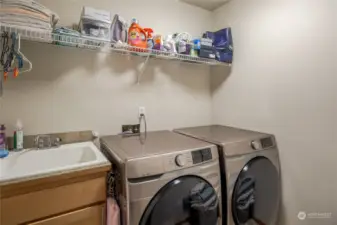 Upstairs laundry room with utility sink