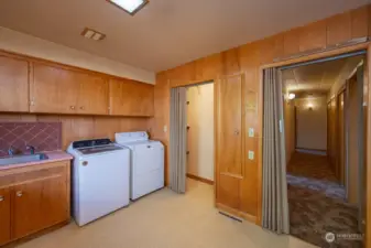 View to the laundry room closet and hallway.