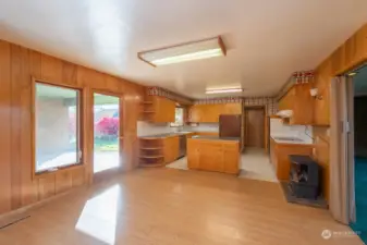 Natural light fills the kitchen. A propane stove adds a bit of extra warmth to this flexible space.