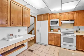 Adjacent to dining room is the kitchen with functional layout and ample storage