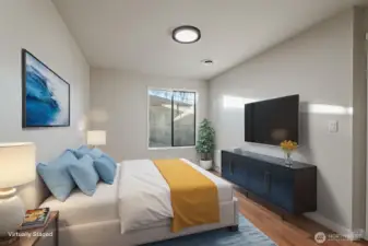 Downstairs bedroom facing the side virtually staged