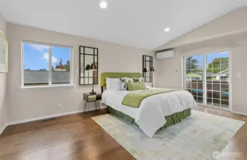 spacious primary bedroom with adjacent deck