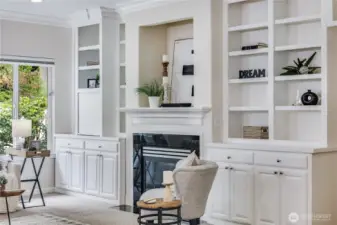 A wall of built-ins accentuates the living room, providing space for collectibles, books, photos, or favorite décor items.