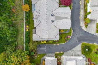 A bird’s eye view of the home shows off the layout of the property, and the two adjacent visitor parking spots. The roof was replaced in the last couple of years.