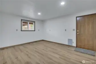 Large extra finished room with door to exterior and plumbing capped off for future use... possible shop/ home office/ gym or...?