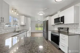 Beautifully updated kitchen w/granite countertops and stainless appliances