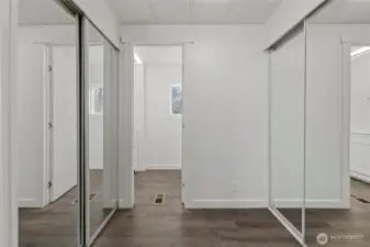 Primary bedroom features double mirrored closets.