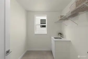 Streamline your laundry routine in this spacious utility room, featuring ample storage and a convenient utility sink, ensuring functionality and ease.