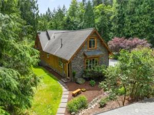 Traditional architectural design, English cottage stone & timber. - Looking at the side view of home and garage.